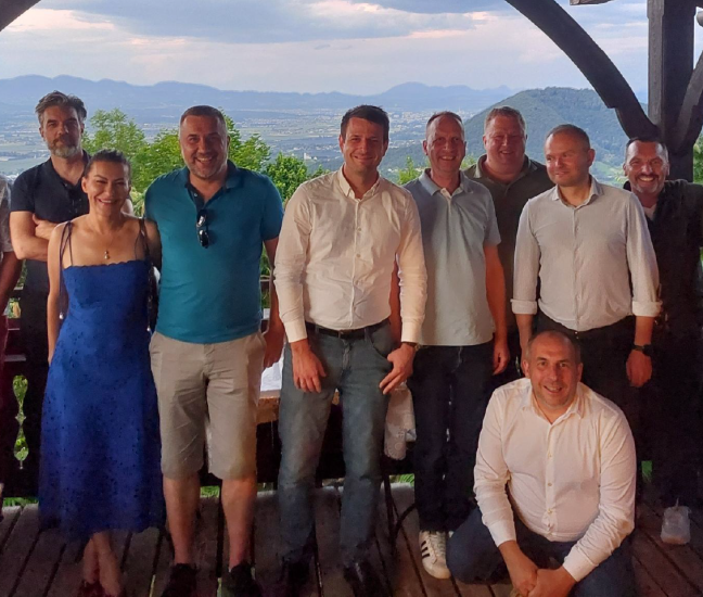 A smiling group photo of international business partners and the Robust team at a networking dinner during the Robust Distributor Event 2026.