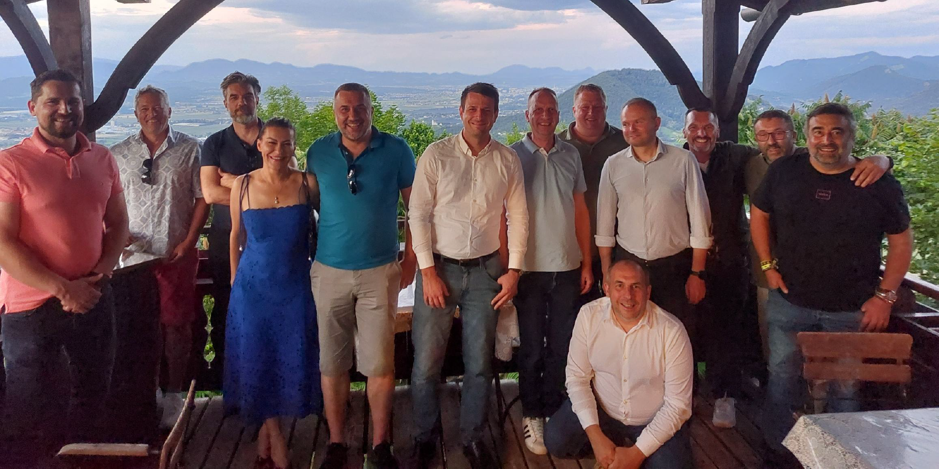A smiling group photo of international business partners and the Robust team at a networking dinner during the Robust Distributor Event 2026.